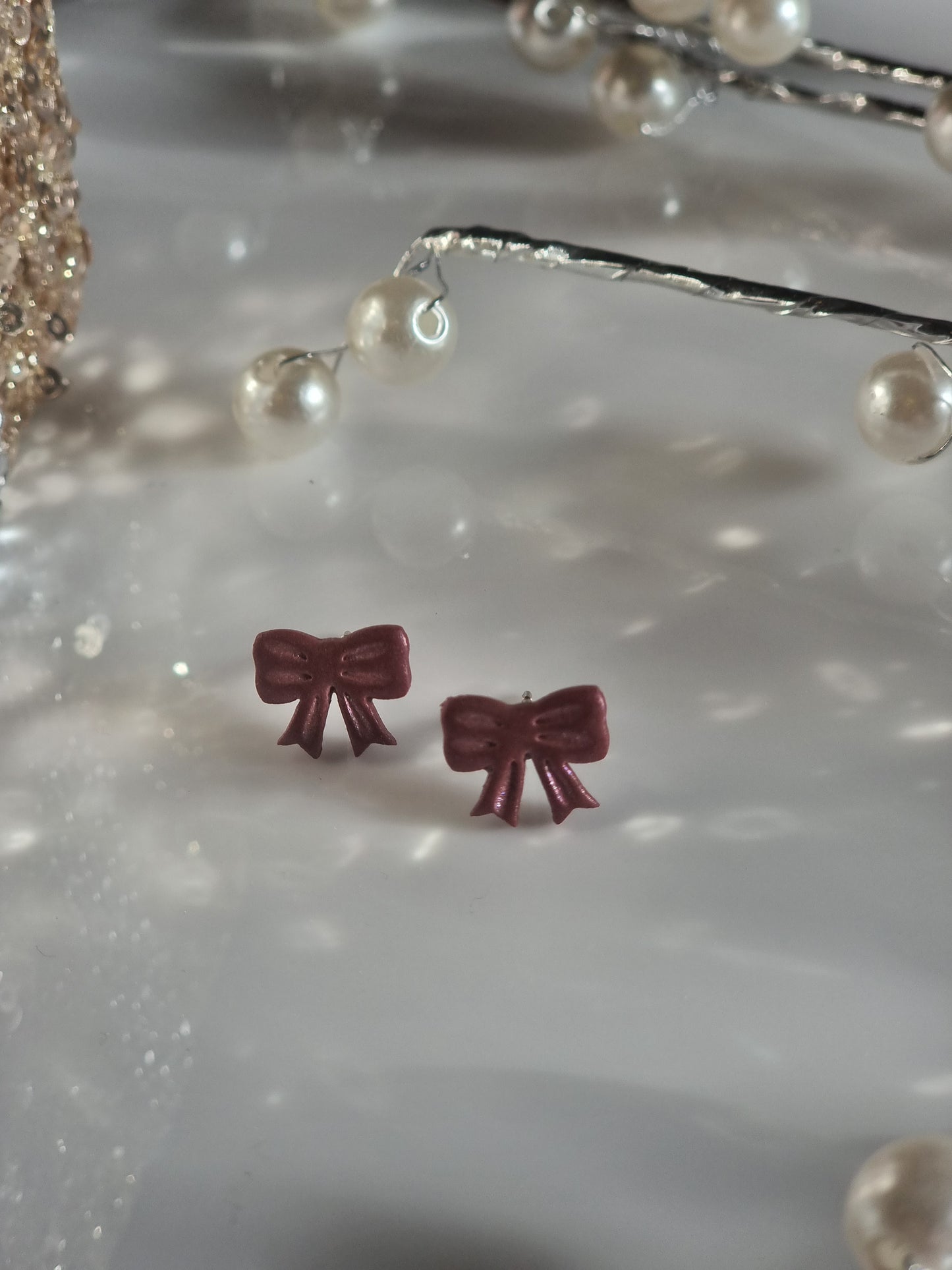 Red shimmer bow studs