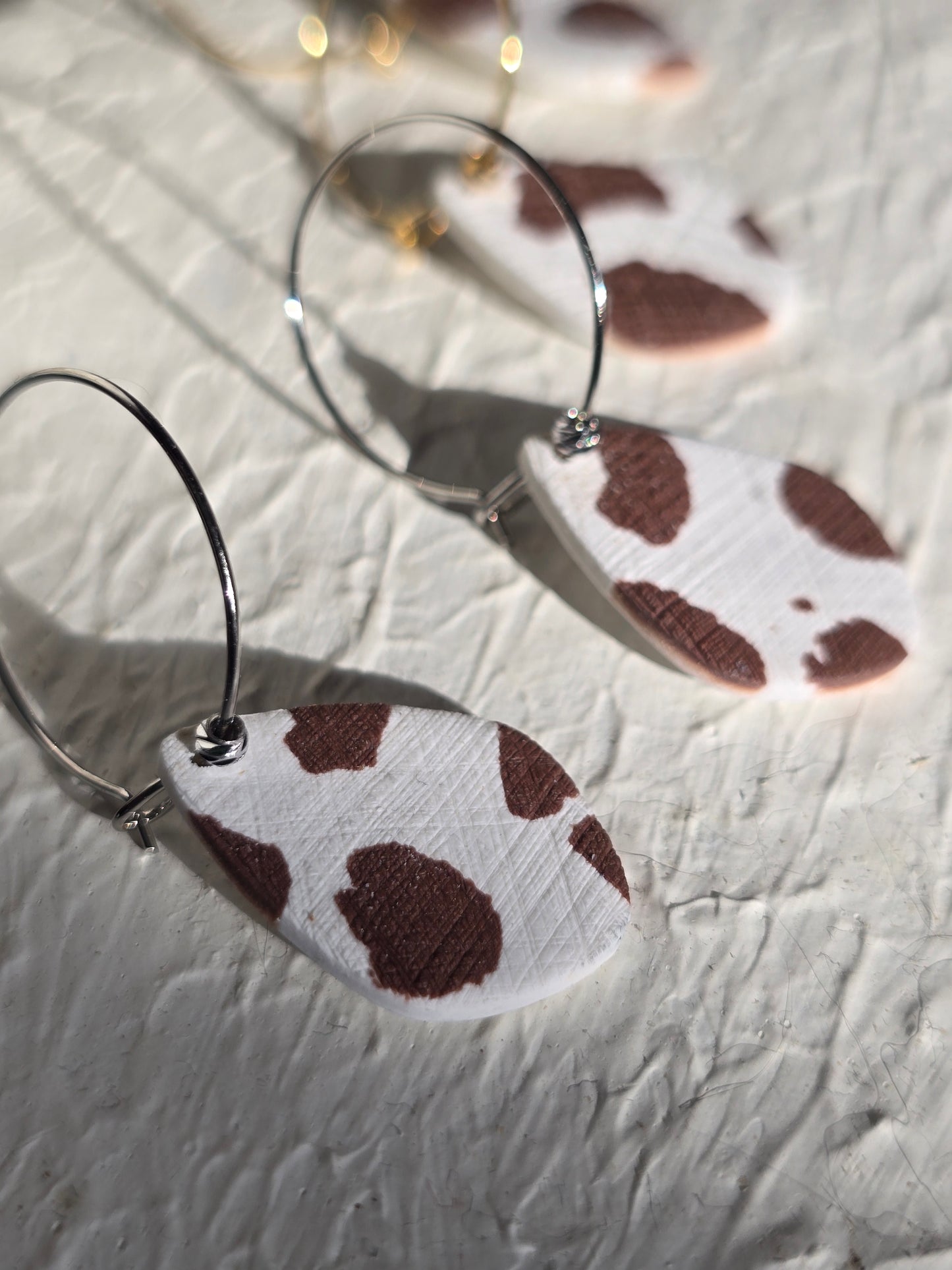 Cow print denim hoops